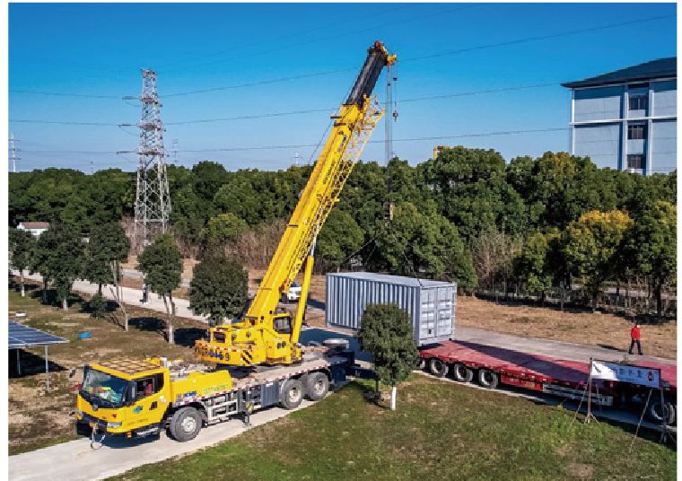 Container hoisted into position by crane